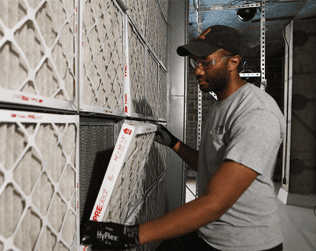 Technician HVAC indoor air quality filters